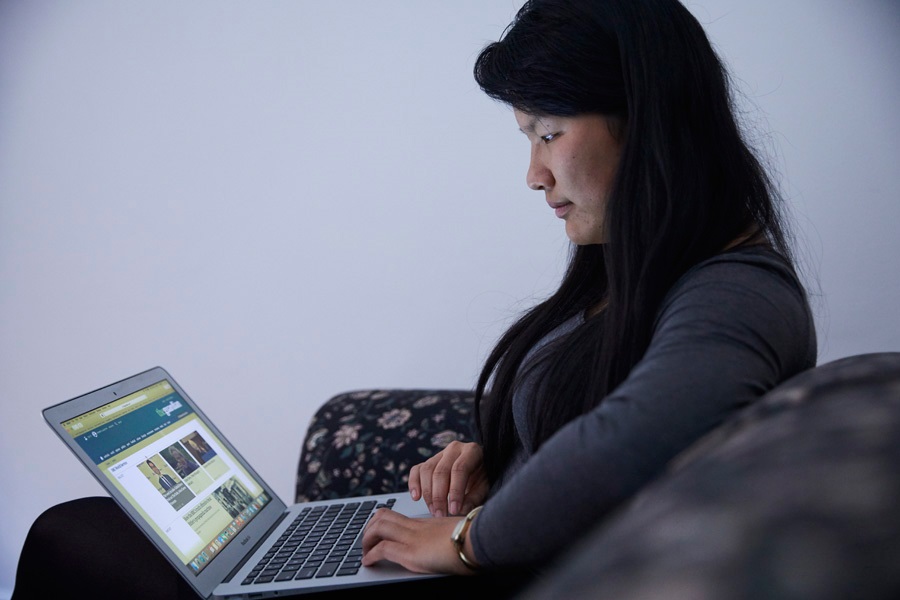 Girl looking at her laptop at home